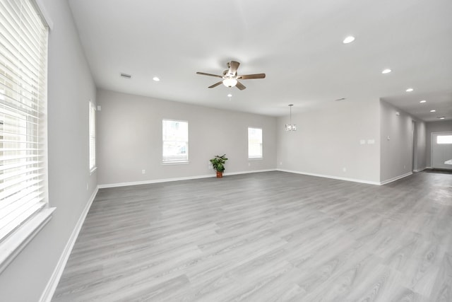 unfurnished living room with ceiling fan, wood finished floors, and recessed lighting