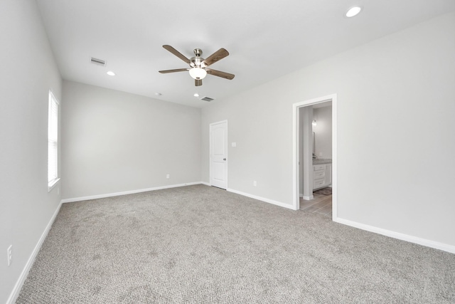 carpeted spare room with recessed lighting, visible vents, ceiling fan, and baseboards