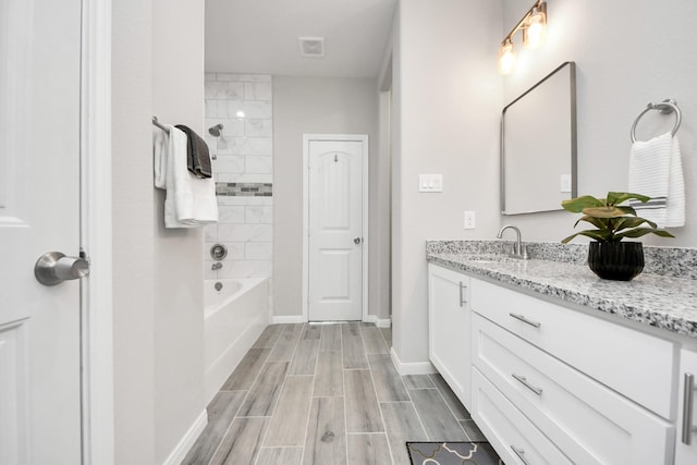 bathroom with wood tiled floor, vanity, baseboards, and bathing tub / shower combination