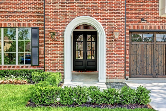 doorway to property with french doors and brick siding