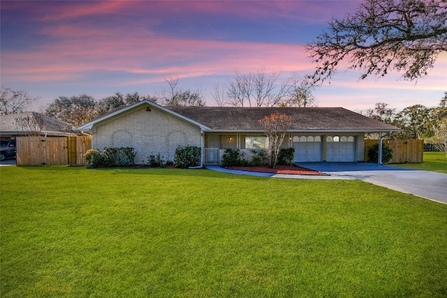 view of front of property featuring a front yard, concrete driveway, brick siding, and fence