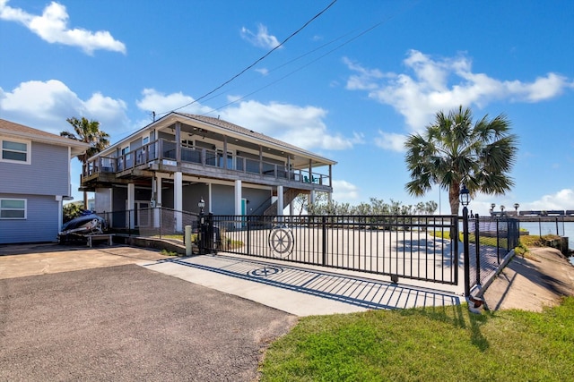 exterior space with a balcony and a fenced front yard