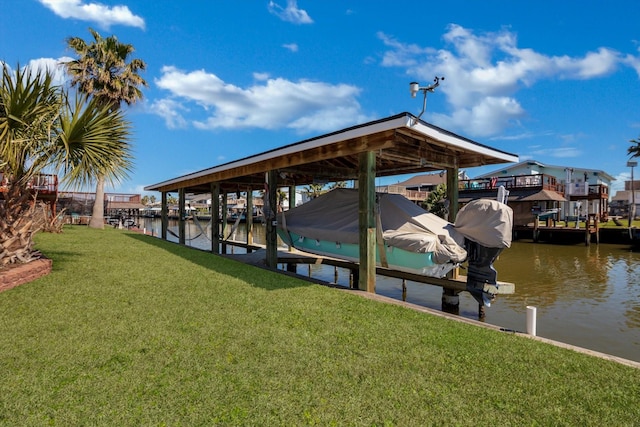 view of dock with a lawn, a water view, and boat lift