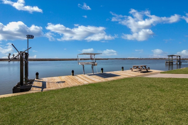 view of dock featuring a water view and a yard