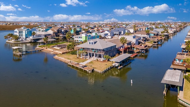 drone / aerial view featuring a water view and a residential view