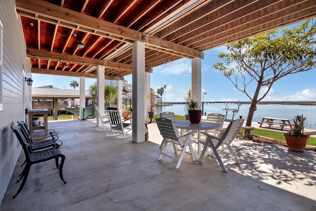 view of patio / terrace featuring a water view and outdoor dining area