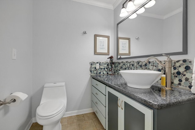 half bathroom featuring ornamental molding, vanity, toilet, and tile patterned floors