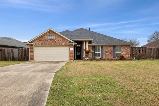 view of front of house with an attached garage, fence, a front lawn, and brick siding