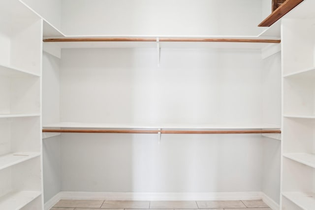 walk in closet featuring tile patterned flooring