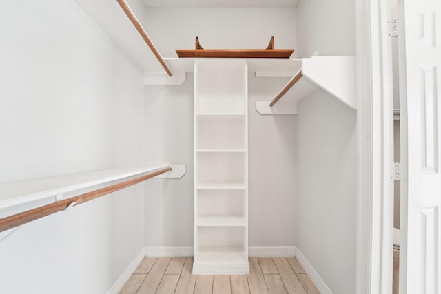 walk in closet with wood tiled floor