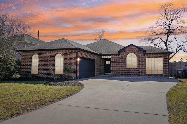 view of front of property with a garage, driveway, brick siding, and a shingled roof