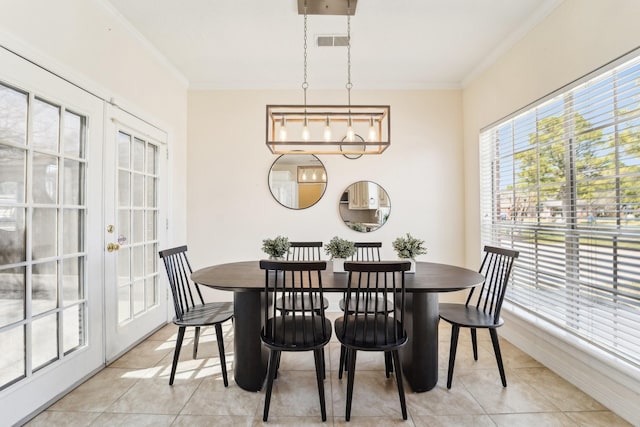 dining area with light tile patterned floors, french doors, visible vents, and crown molding