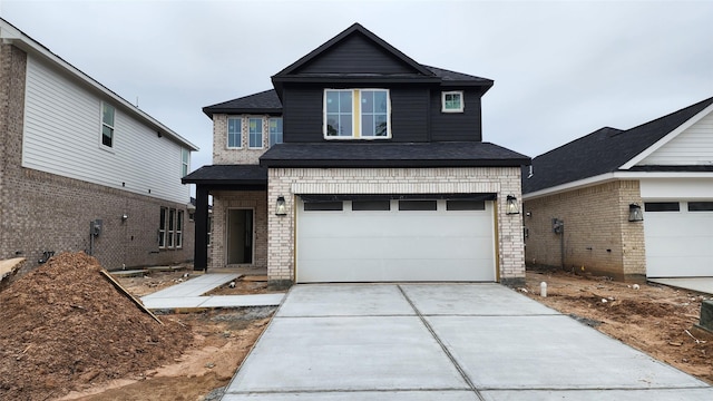 view of front facade featuring driveway, brick siding, and an attached garage