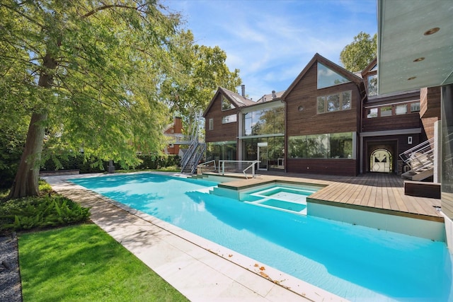 pool featuring stairs and a wooden deck