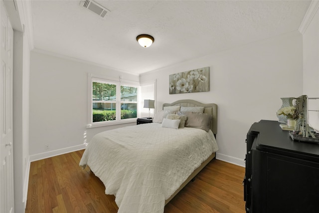 1931 Ansbury Dr, Houston, TX 77018 - bedroom featuring baseboards, wood finished floors, visible vents, and crown molding