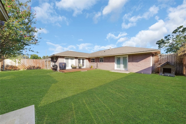 1931 Ansbury Dr, Houston, TX 77018 - back of house with a fenced backyard, brick siding, french doors, a lawn, and a patio area