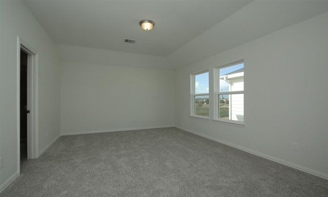 carpeted empty room with visible vents and baseboards