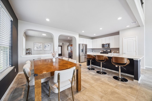 dining room with baseboards, visible vents, and recessed lighting