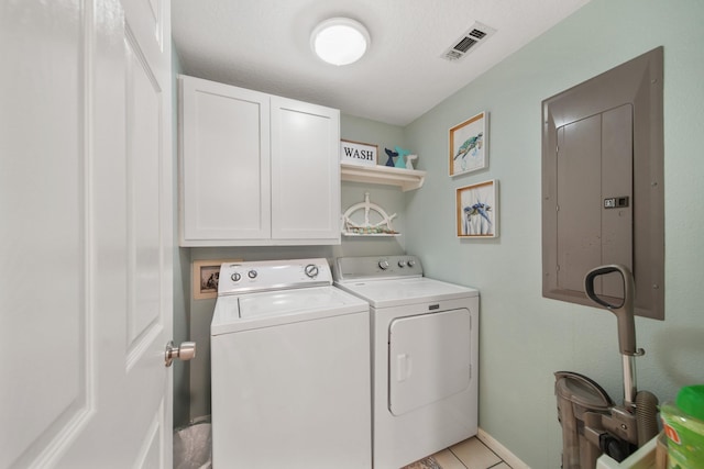 laundry area with washing machine and clothes dryer, cabinet space, visible vents, electric panel, and baseboards