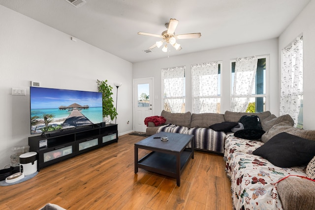 living room with visible vents, hardwood / wood-style flooring, and a ceiling fan