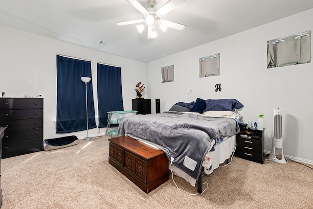 carpeted bedroom with ceiling fan and visible vents