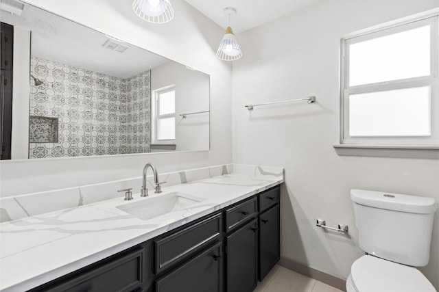 bathroom with toilet, vanity, baseboards, a shower, and tile patterned floors