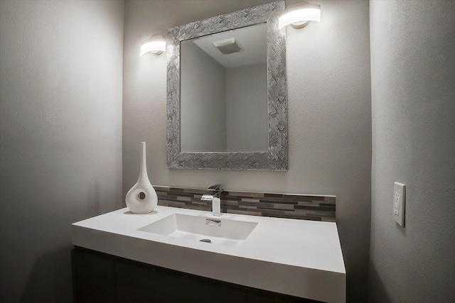 bathroom with backsplash and vanity