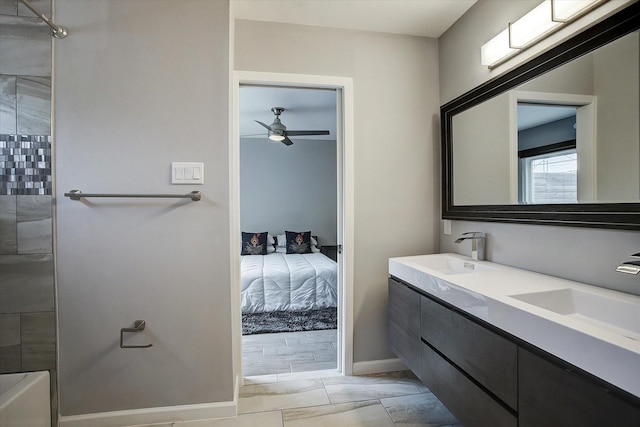 ensuite bathroom with double vanity, a sink, a ceiling fan, and connected bathroom