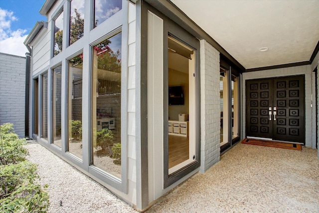 entrance to property with brick siding