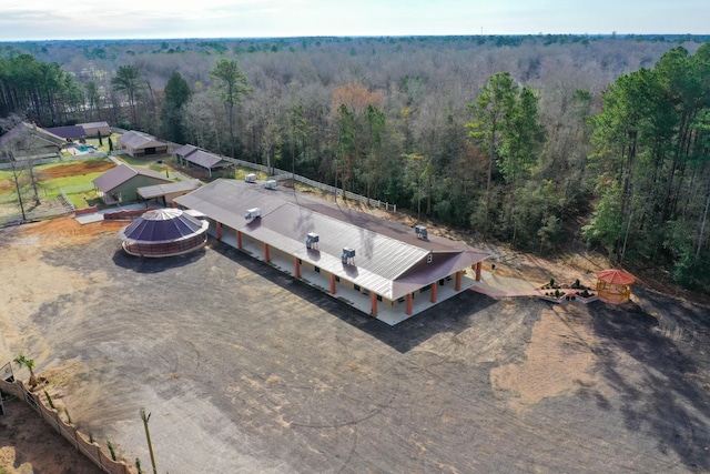 bird's eye view featuring a wooded view