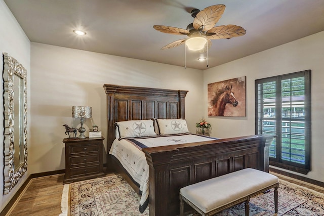 bedroom featuring ceiling fan, recessed lighting, wood finished floors, and baseboards