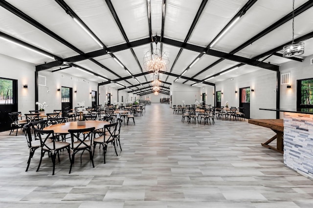 dining room featuring a chandelier and vaulted ceiling with beams