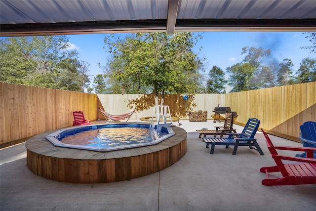 view of patio / terrace featuring a fenced backyard and an outdoor hot tub