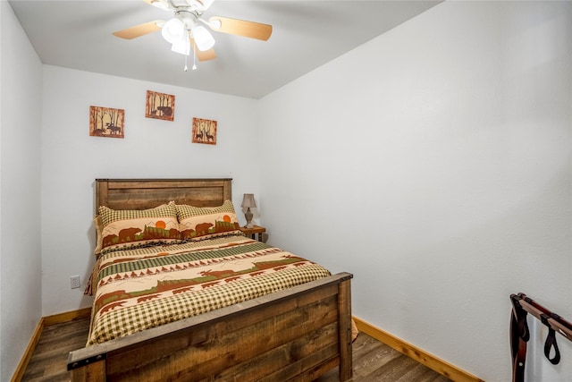 bedroom with ceiling fan, baseboards, and wood finished floors