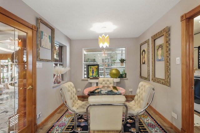 dining area featuring baseboards and wood finished floors