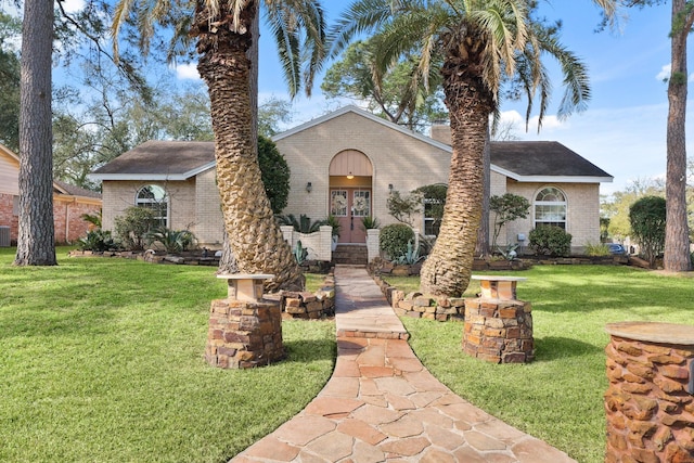 view of front of home featuring brick siding and a front yard