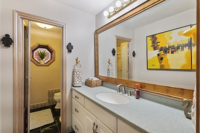 bathroom featuring vanity and toilet