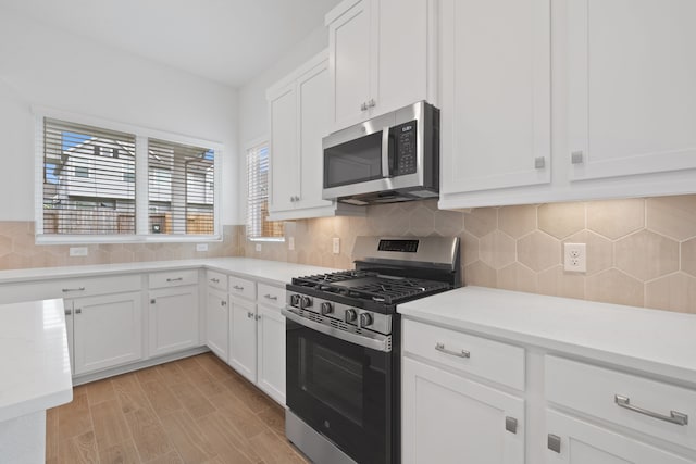 164 W Coralburst Loop, Montgomery, TX 77316 - kitchen with appliances with stainless steel finishes, light countertops, and white cabinets