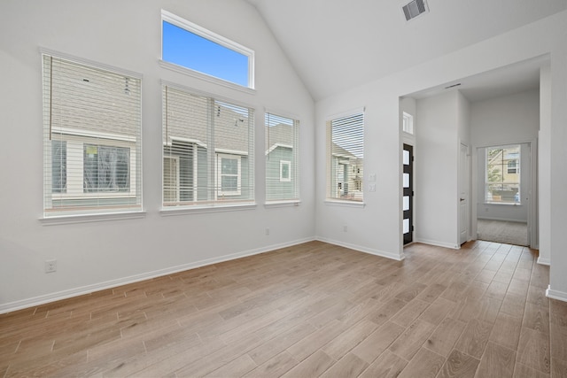 164 W Coralburst Loop, Montgomery, TX 77316 - empty room featuring high vaulted ceiling, light wood-style floors, and baseboards