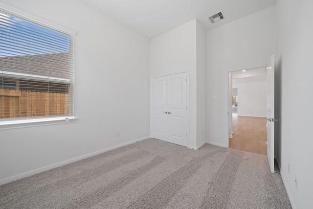 164 W Coralburst Loop, Montgomery, TX 77316 - unfurnished bedroom featuring carpet, multiple windows, a closet, and baseboards