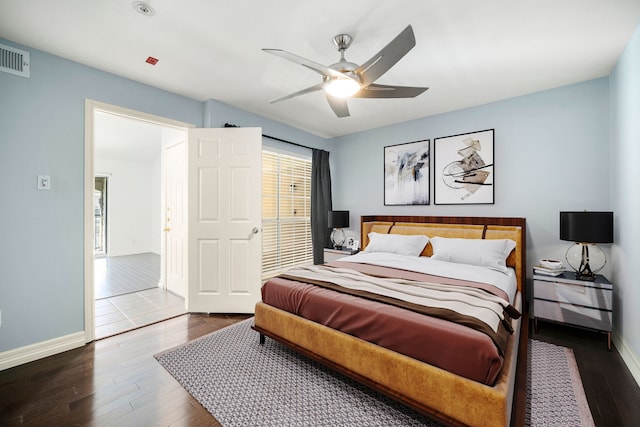 bedroom with visible vents, a ceiling fan, hardwood / wood-style flooring, and baseboards