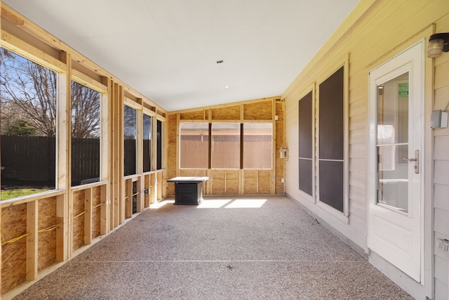 unfurnished sunroom with vaulted ceiling