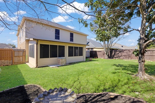 back of house with a sunroom, a fenced backyard, and a yard