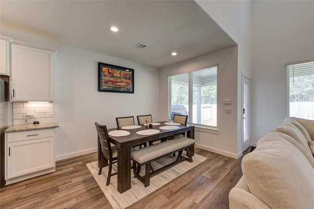 dining area featuring recessed lighting, a healthy amount of sunlight, baseboards, and wood finished floors