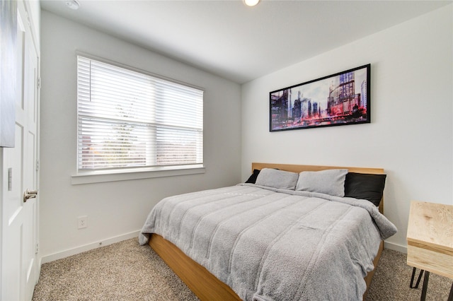 bedroom with carpet floors and baseboards