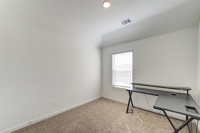 unfurnished office with carpet, visible vents, and baseboards