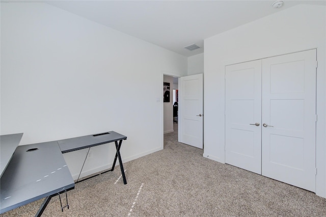 carpeted office space featuring baseboards and visible vents