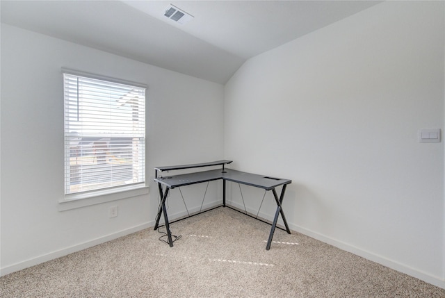 interior space featuring visible vents, baseboards, vaulted ceiling, and light colored carpet