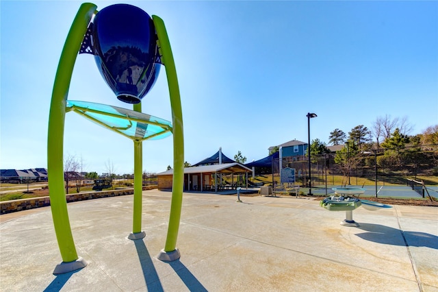 view of basketball court featuring fence