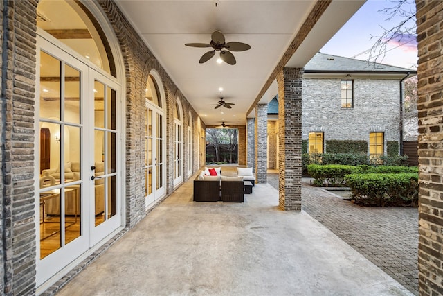 view of patio with an outdoor living space, a ceiling fan, and french doors